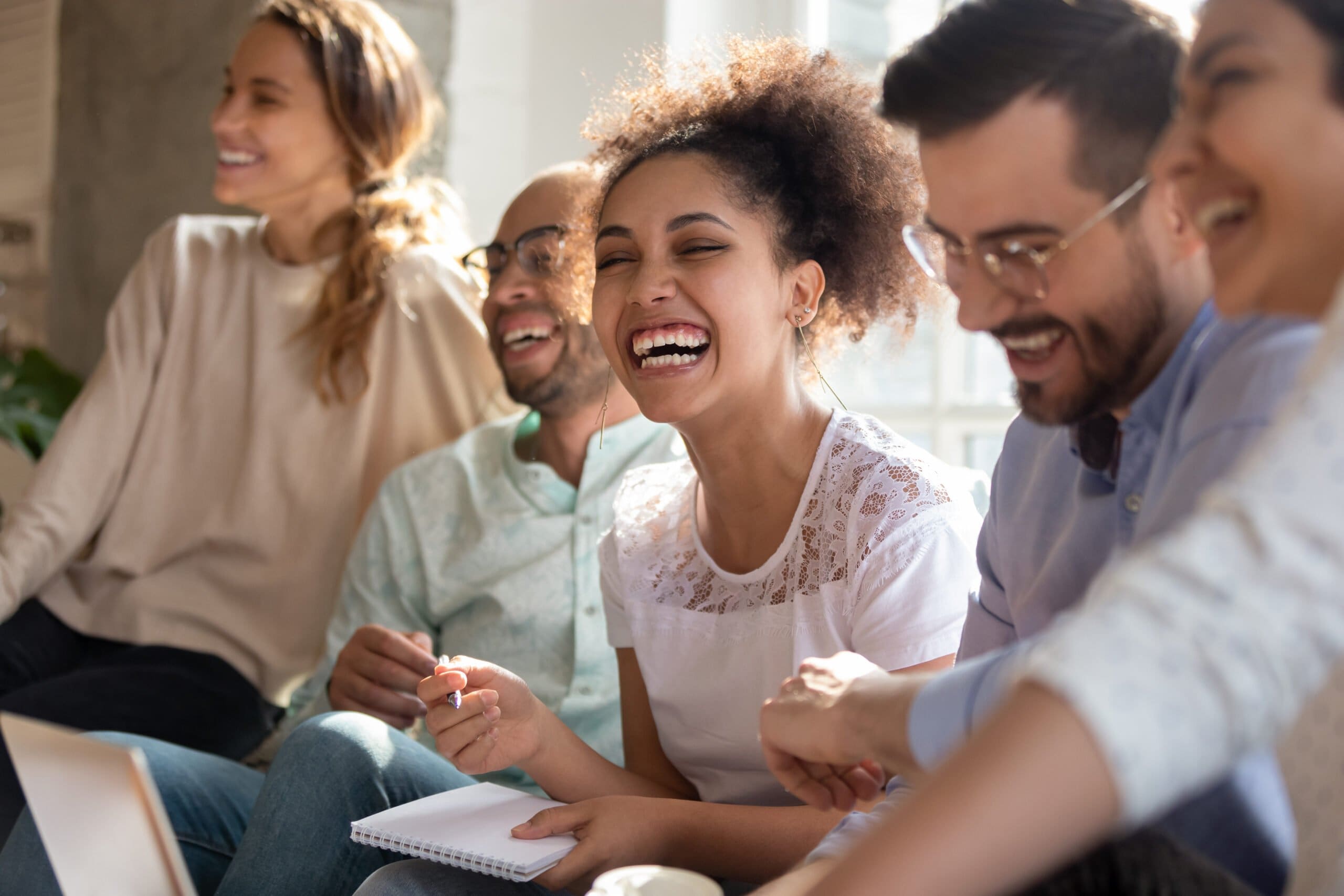 Overjoyed,Multiracial,Young,People,Sit,In,Row,Have,Fun,Laughing